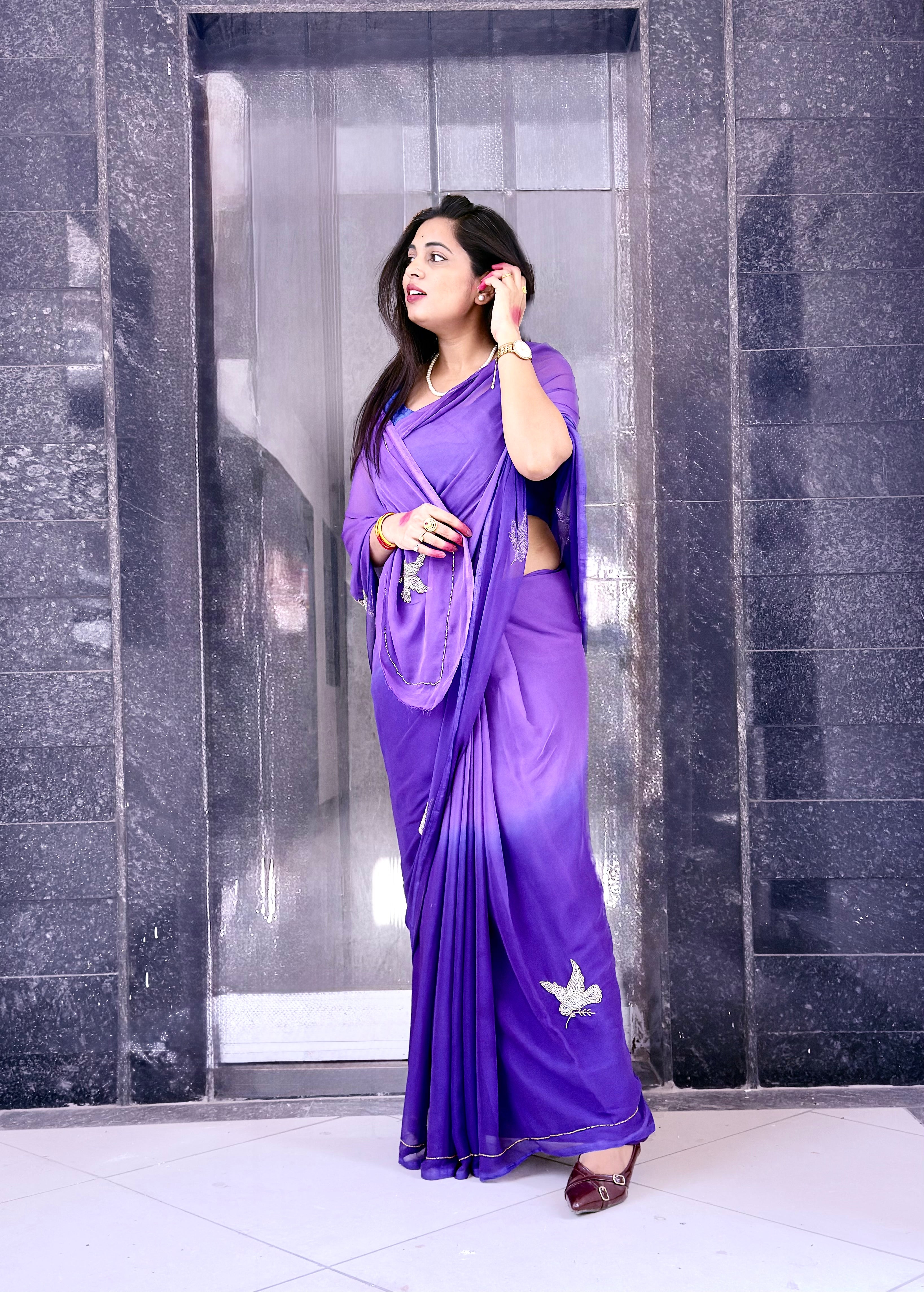 An exquisite purple chiffon saree with intricate bird embroidery, designed to add effortless elegance to your wardrobe