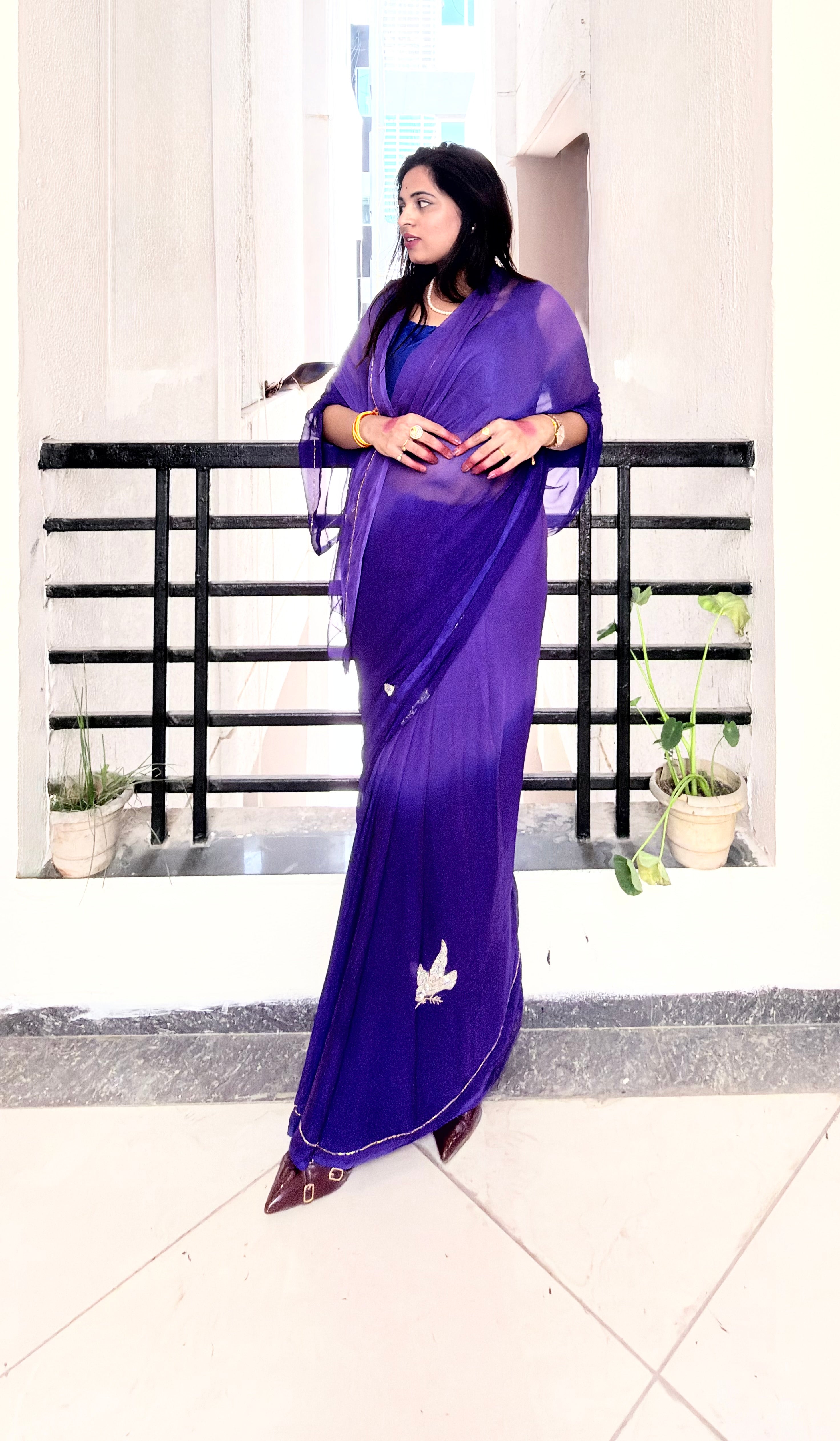 An exquisite purple chiffon saree with intricate bird embroidery, designed to add effortless elegance to your wardrobe