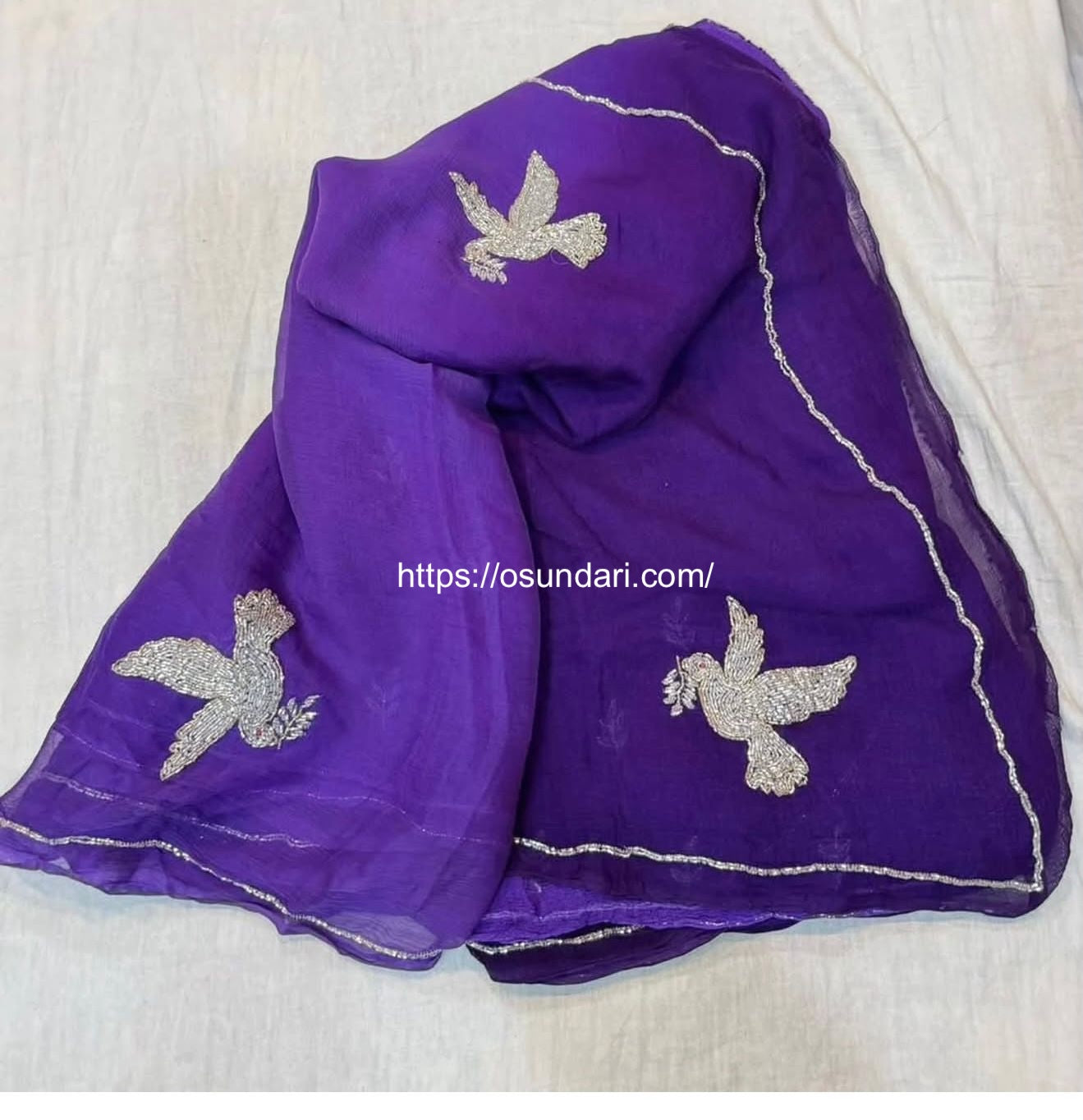 An exquisite purple chiffon saree with intricate bird embroidery, designed to add effortless elegance to your wardrobe